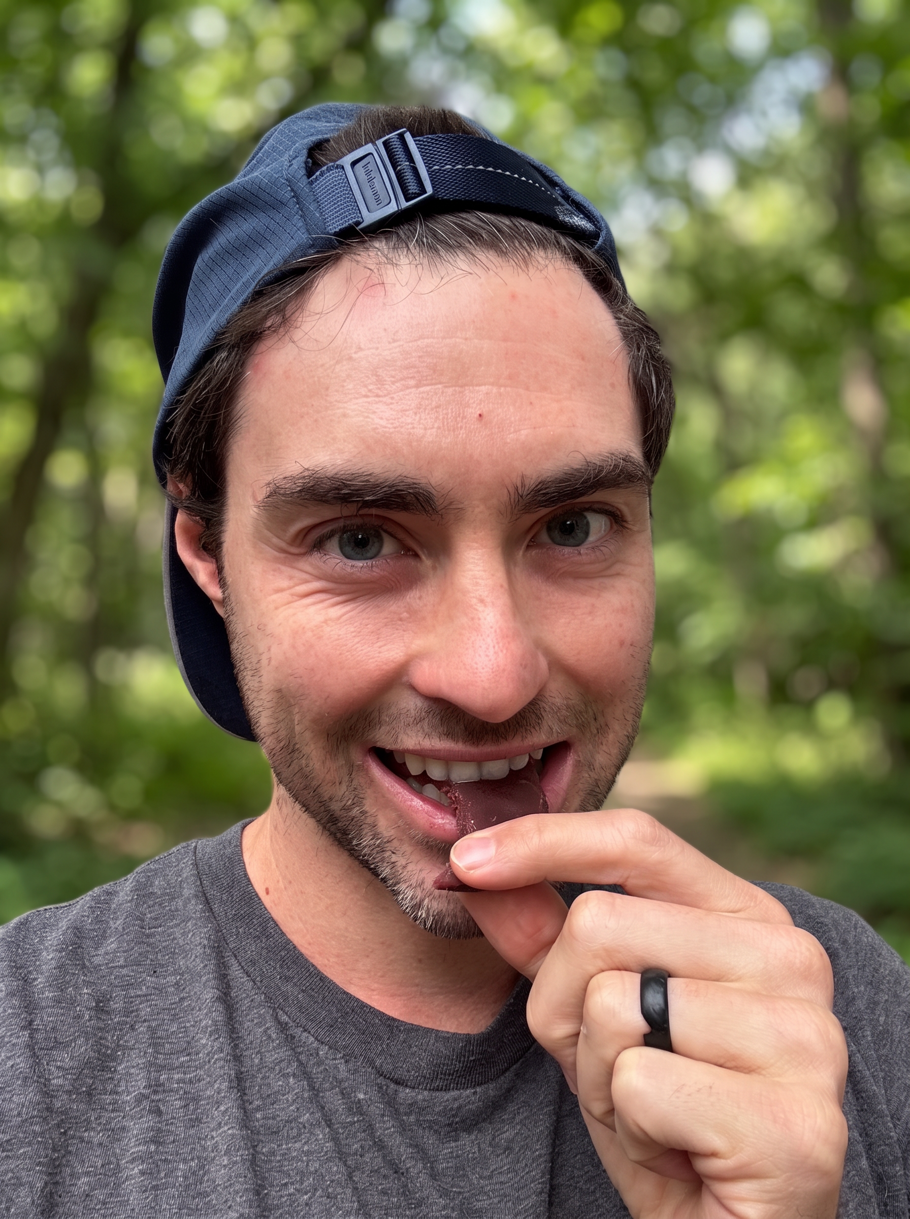 Robbie, founder of GoDough, eating a GoDough bite outdoors